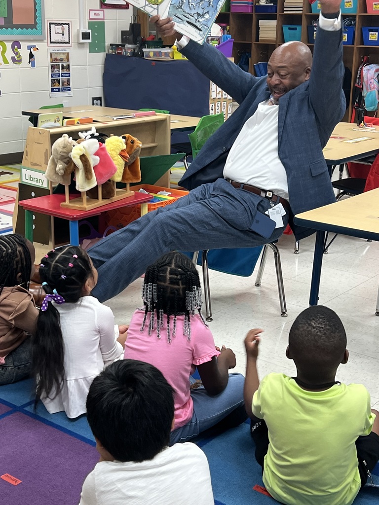 Dr. Lockhart acting out the story by lifting his hands and smiling
