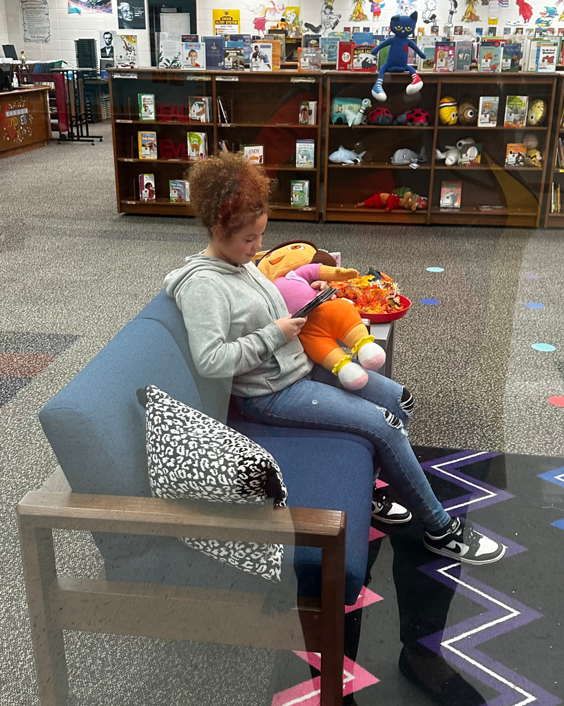 student reading on couch in the library