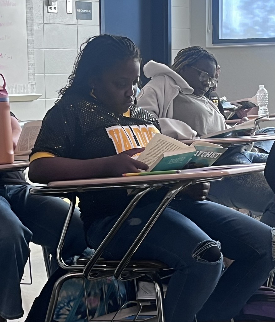 student reading at desk
