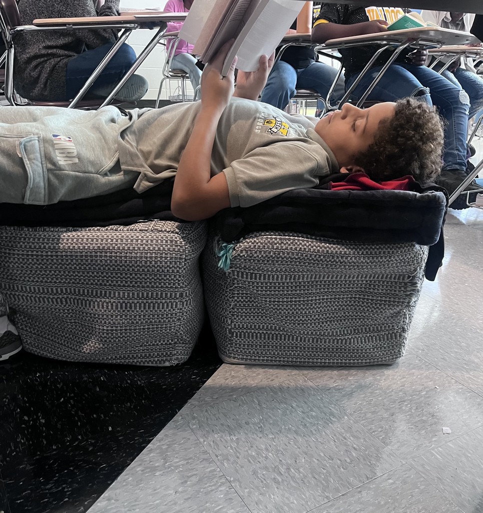 student reading on couch cushions