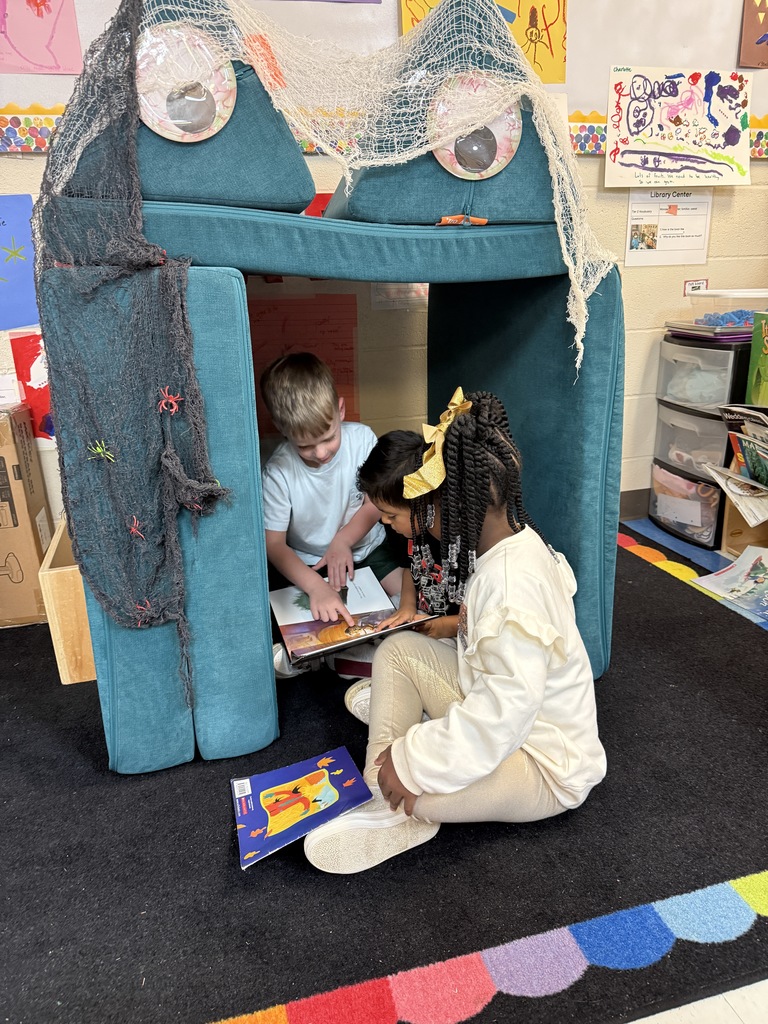 students reading in a fort created by teacher known as the "monster cave"