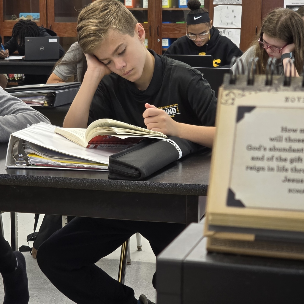 student at desk, reading