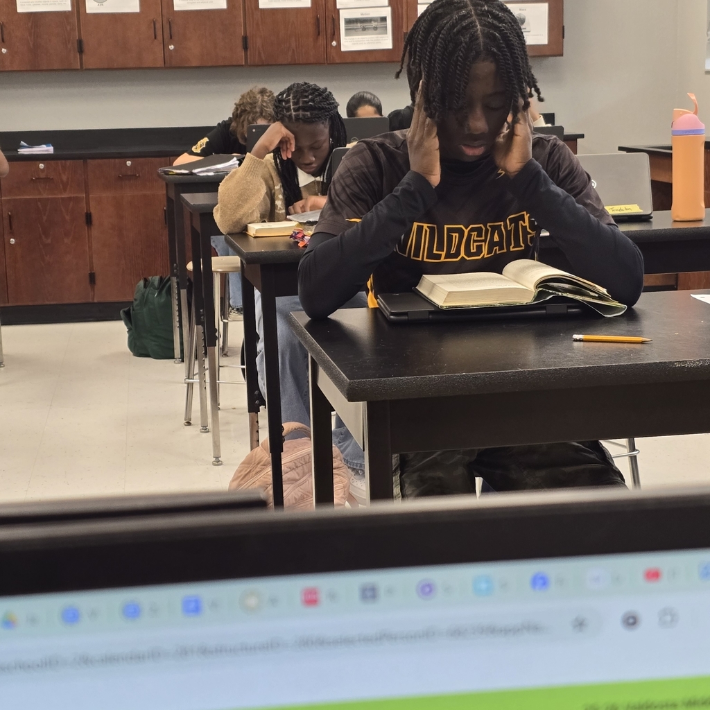 student at desk, reading