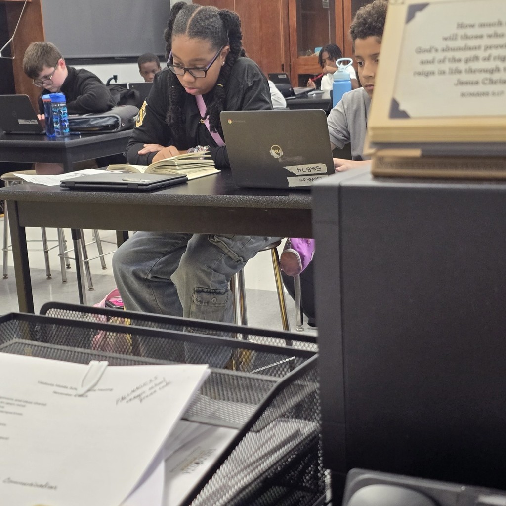 student at desk, reading