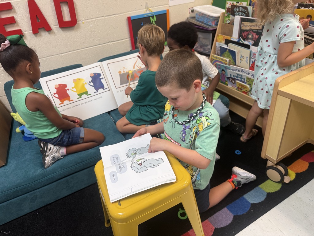 students looking at open books while sitting