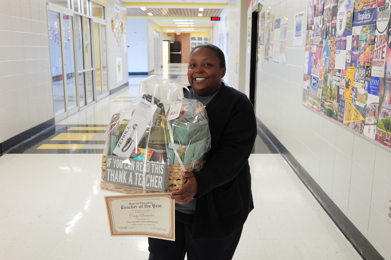 teacher of the year, holding basket and certificate