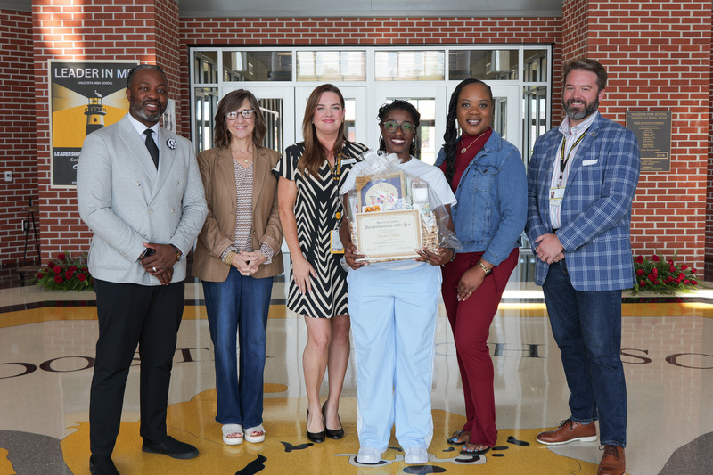 group photo of para of the year with admin and basket and certificate
