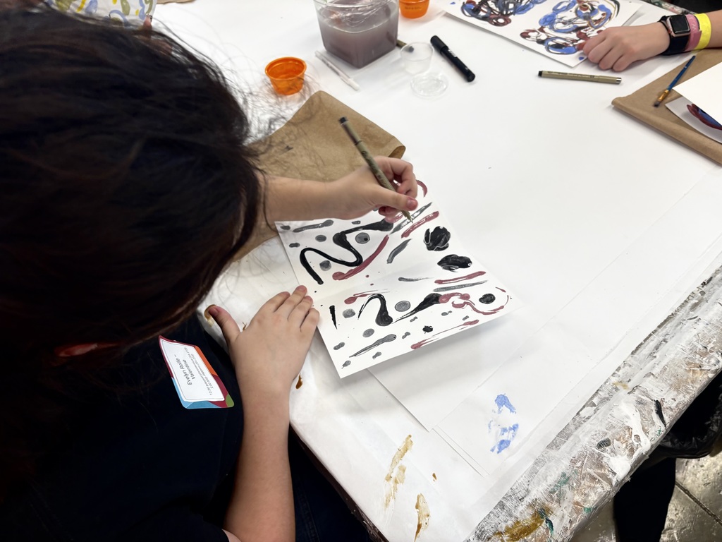 Evelyn Rolfe participating in an abstract painting and drawing.