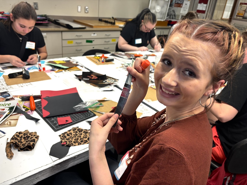 Jessalyn Welch creating a collage with scraps and magazines. 