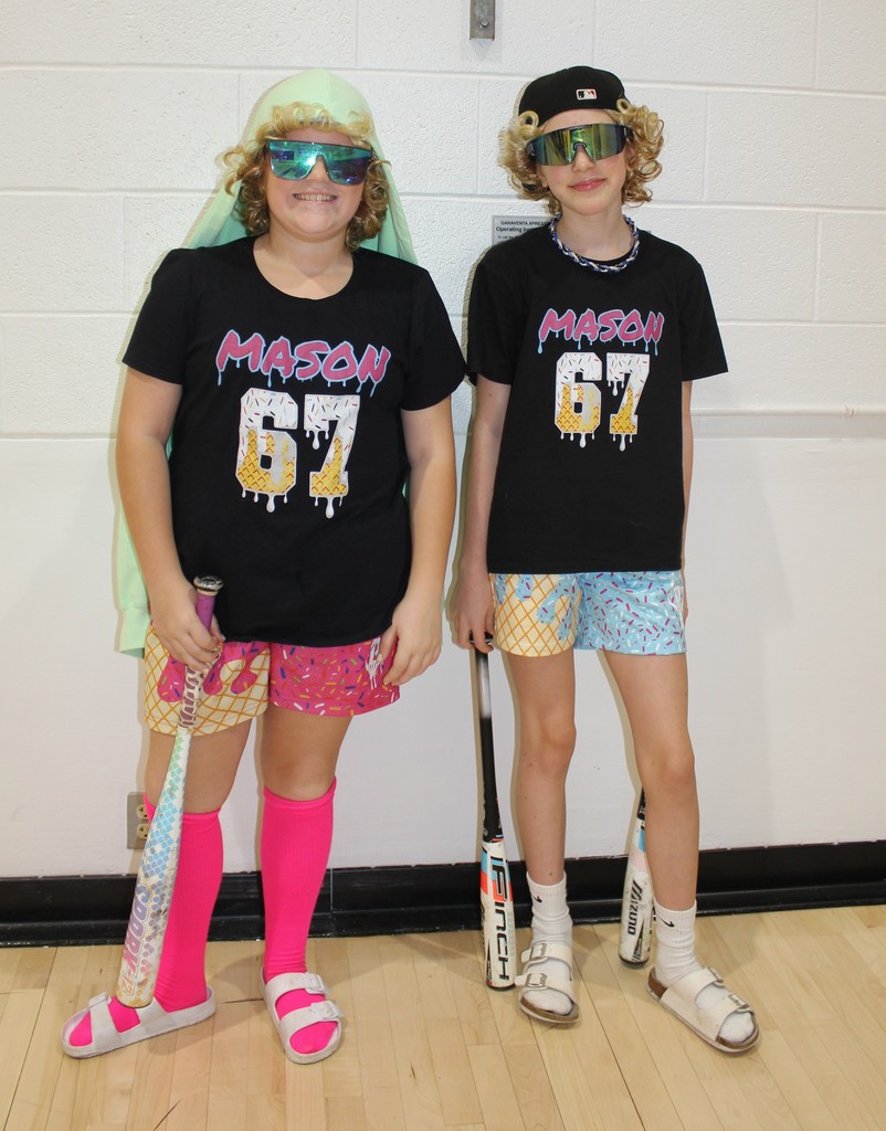 2 girls dressed up softball team