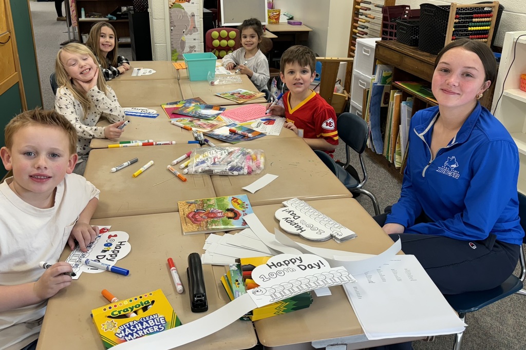 Student Leader with kids at table