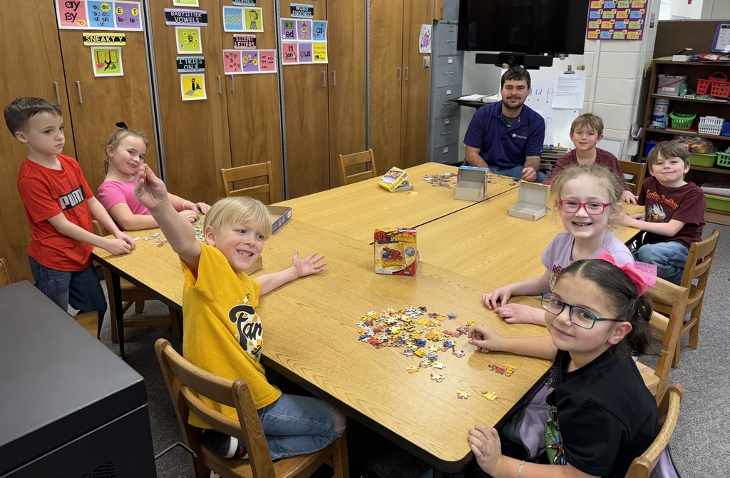 Student Leader with kids at table