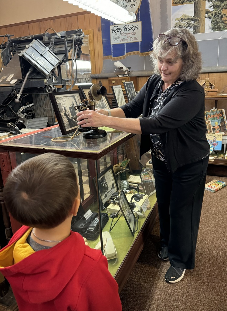 Dawna demonstrating antique phone