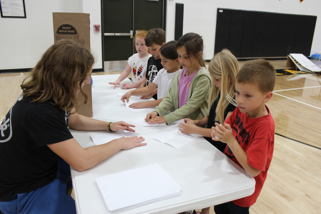 Kids making paper airplanes