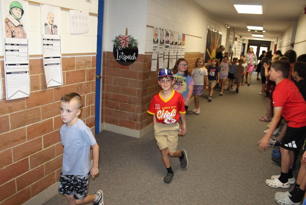 Kids walking down hallway