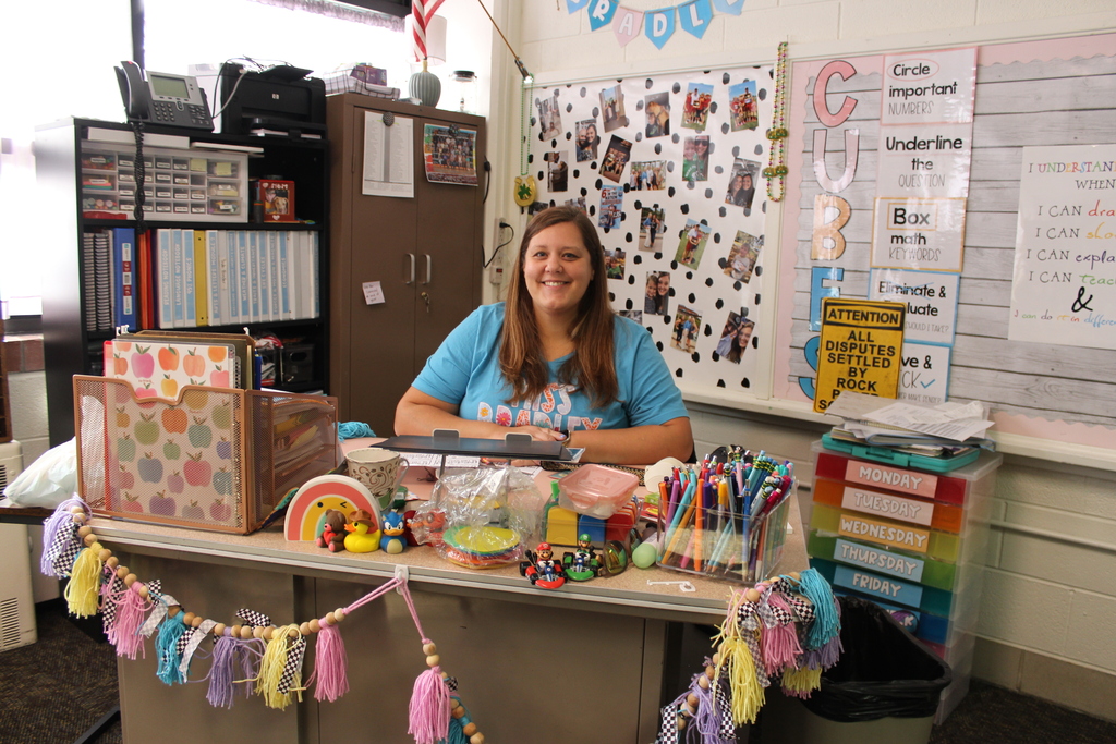 Kristy behind desk