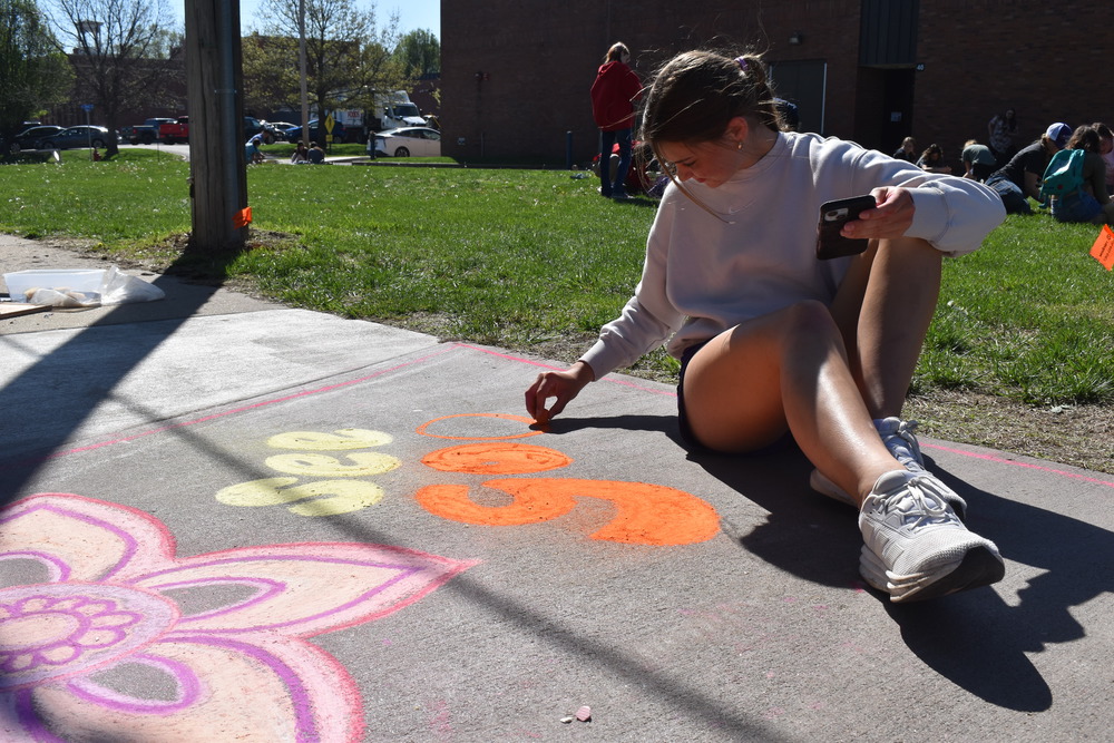 Eleanor Toerber doing sidewalk chalk.