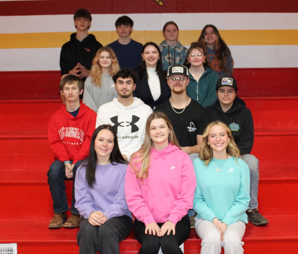 Students posing on bleachers