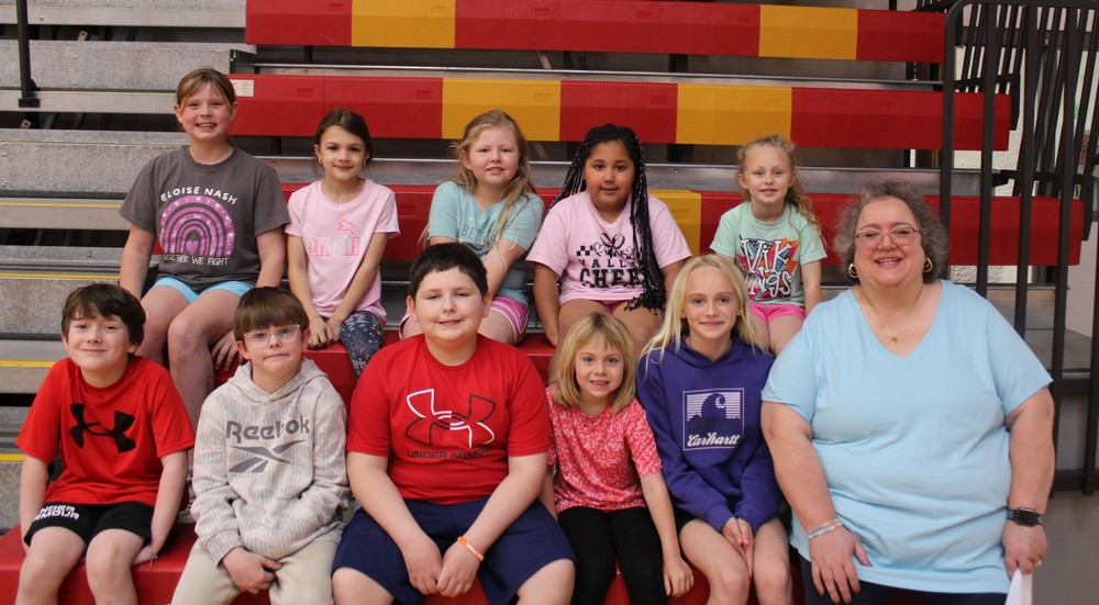 Group of students seated on bleachers