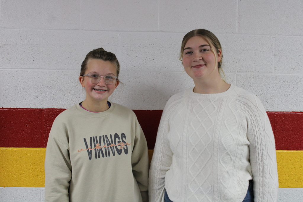 Two students smiling and posing for picture