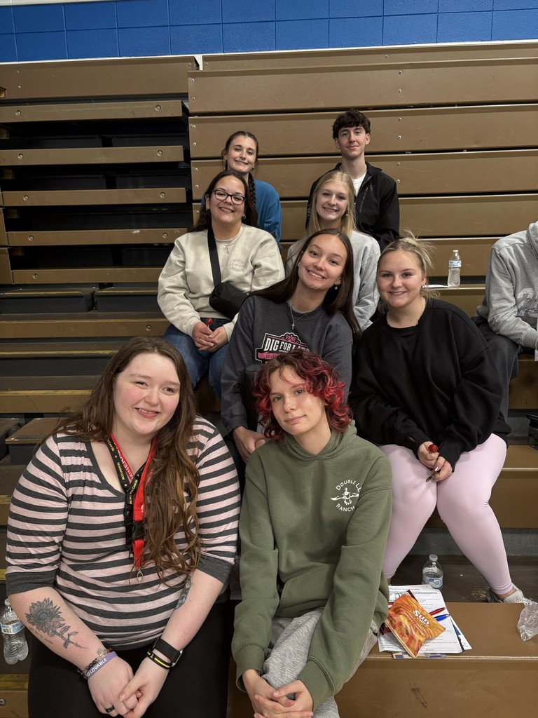 Students posing in bleachers