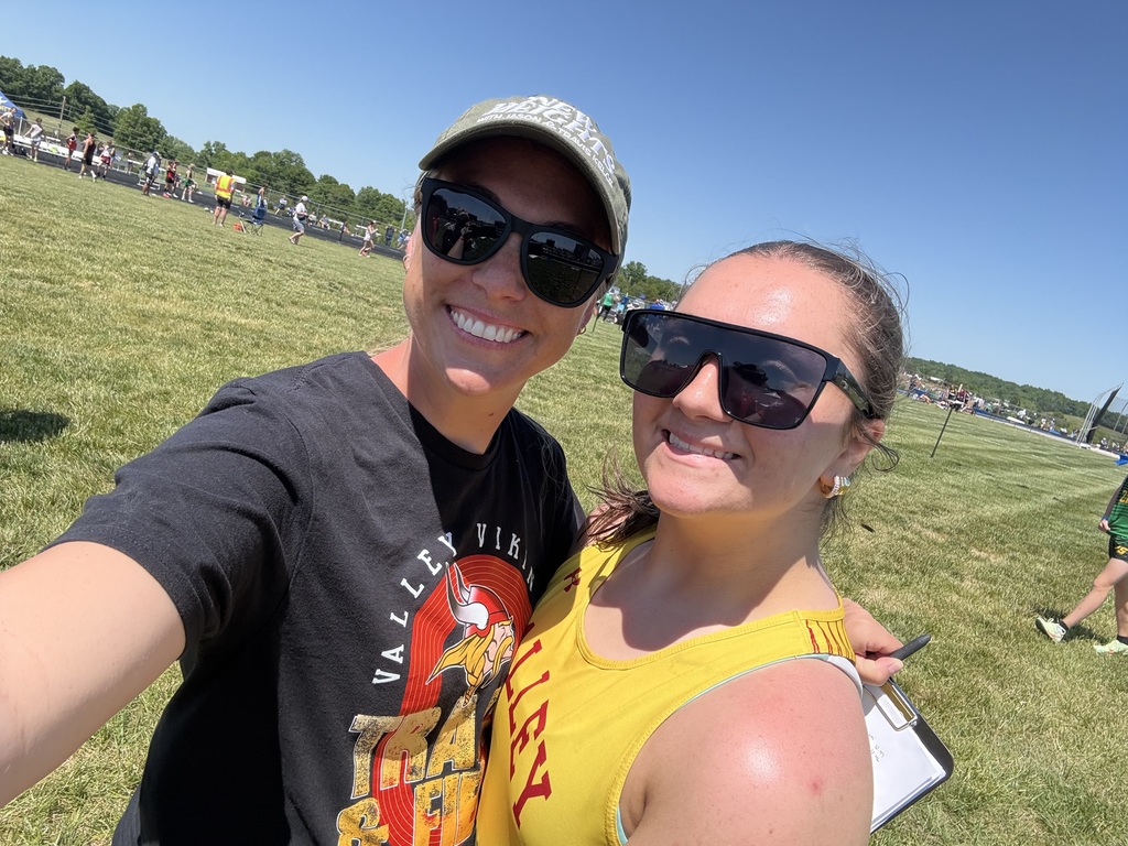Student Posing with Teacher at track meet