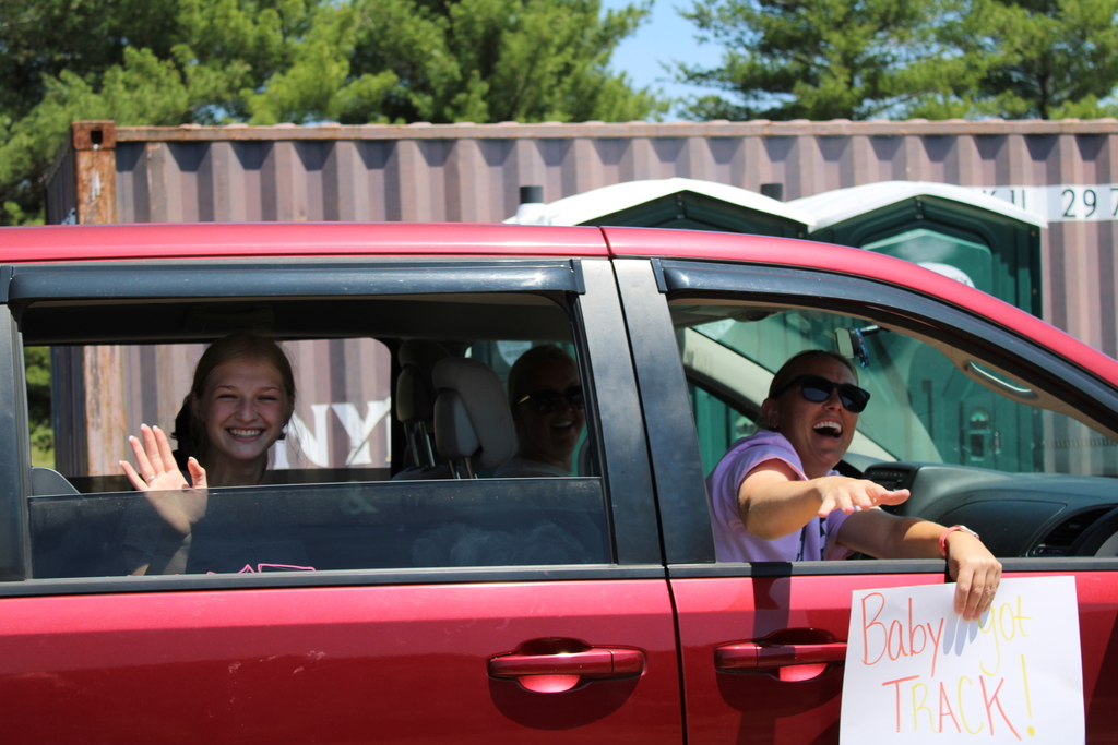 Student in car waiving 