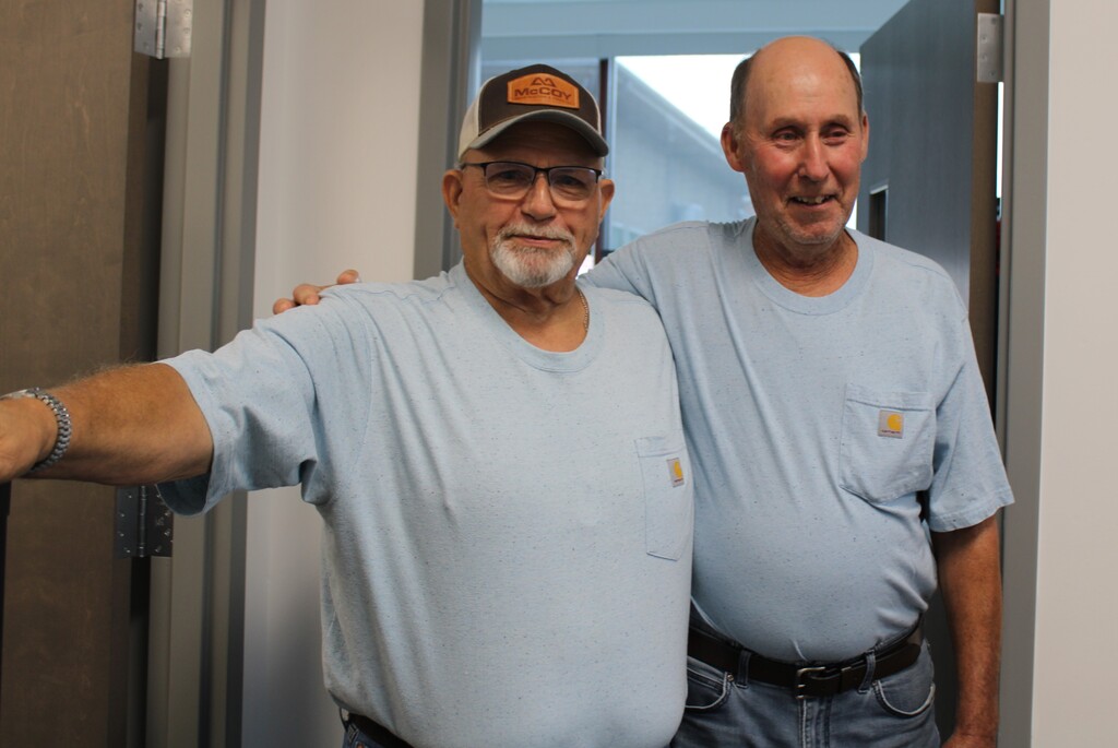 Two men standing and posing