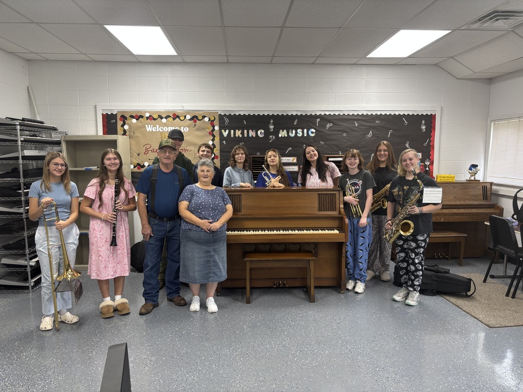 Students and Ed and Wanda in front of Piano
