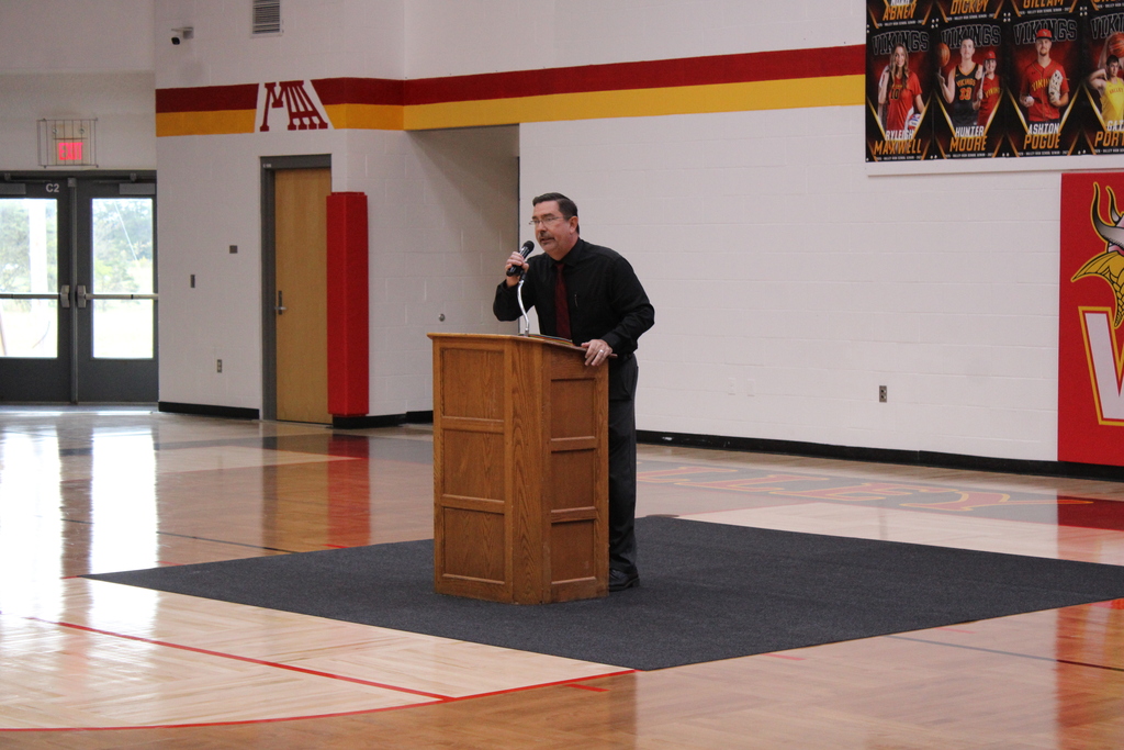 man speaking at podium