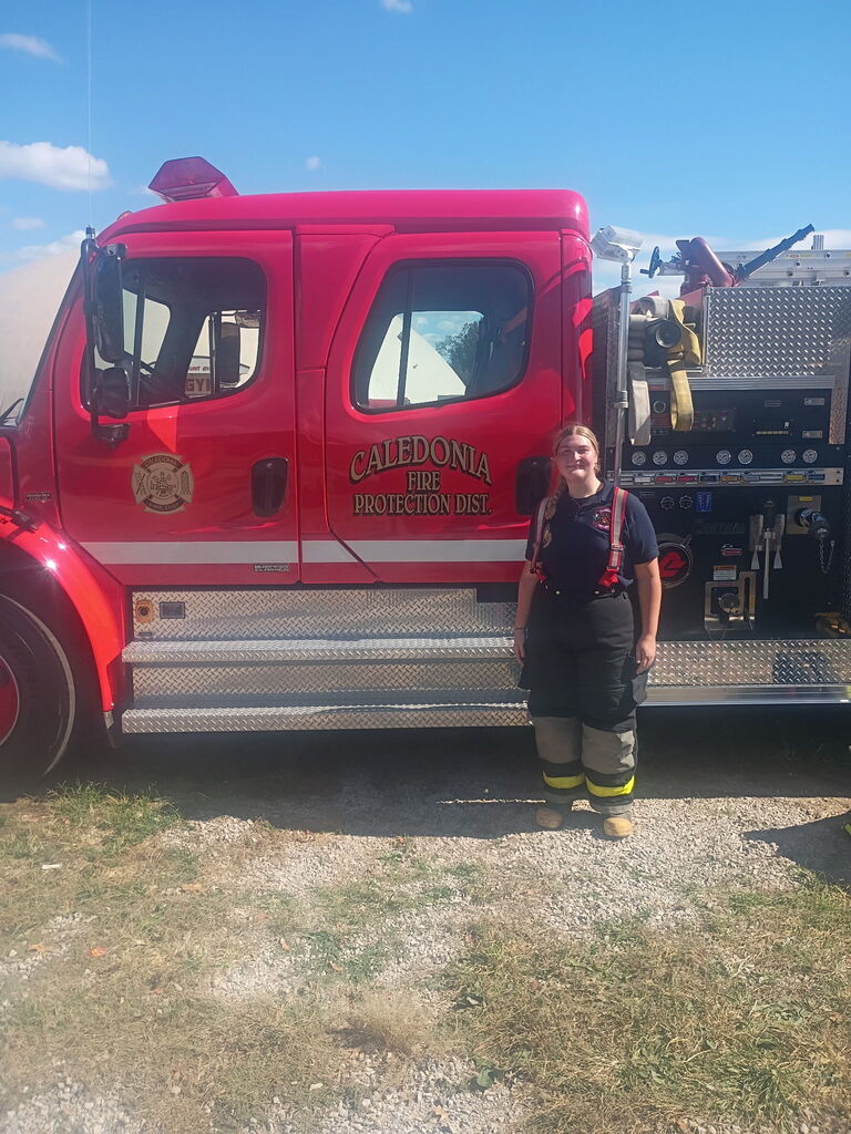 Student in front of fire truck