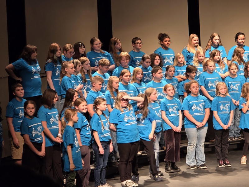 Students posing on stage