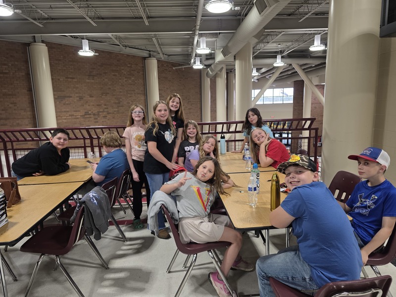 Students sitting at a table posing