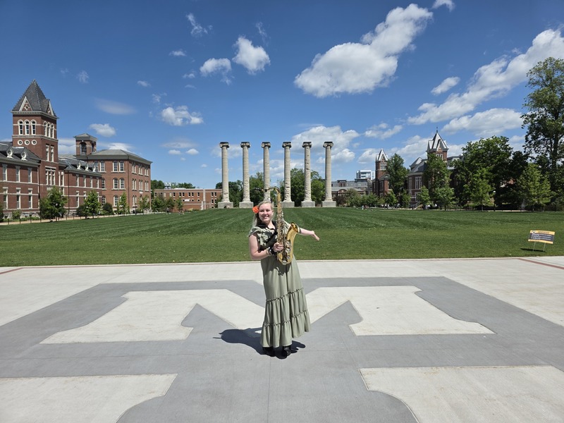 Student posing with instrument at Mizzou