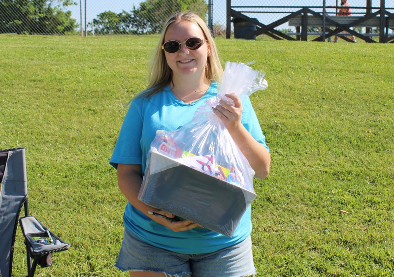 student with basket on grass