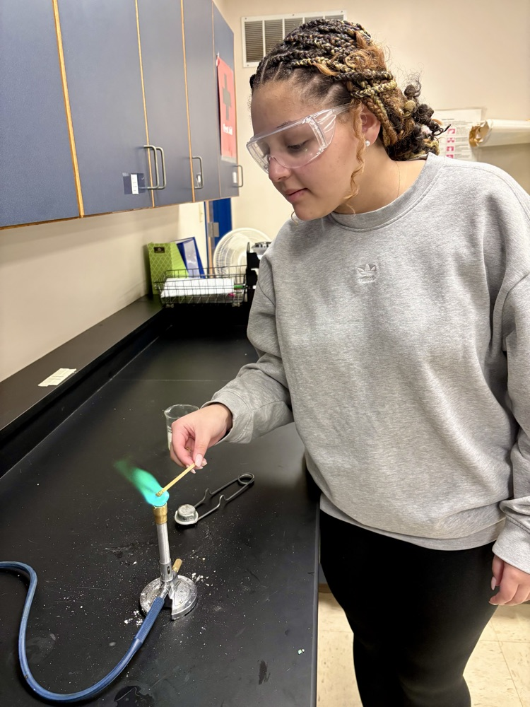 girl doing flame test lab