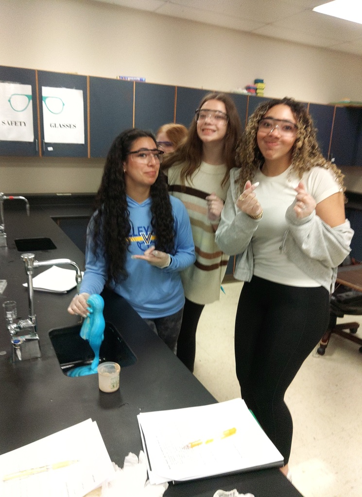 students in science lab with foaming expierment