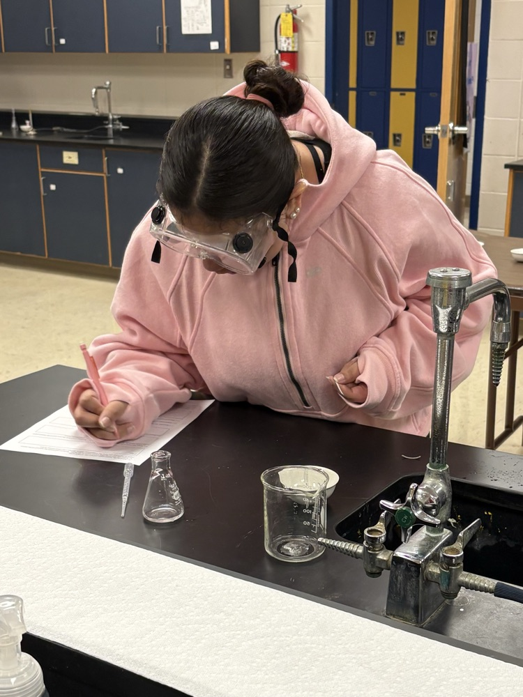 student making lab notes
