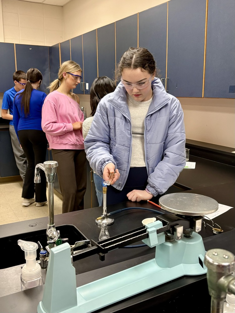 student burning magnesium in lab