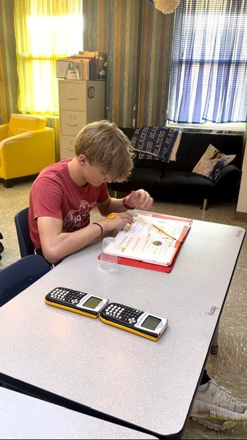 math student seated at a table