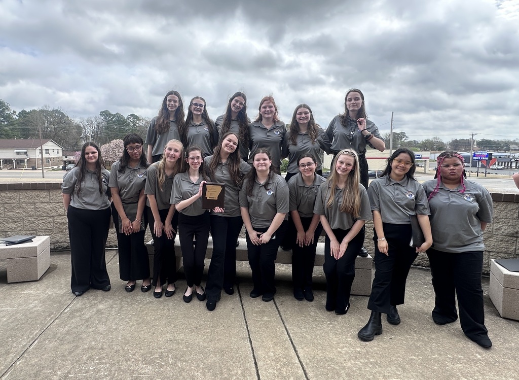 girl choir students with trophey