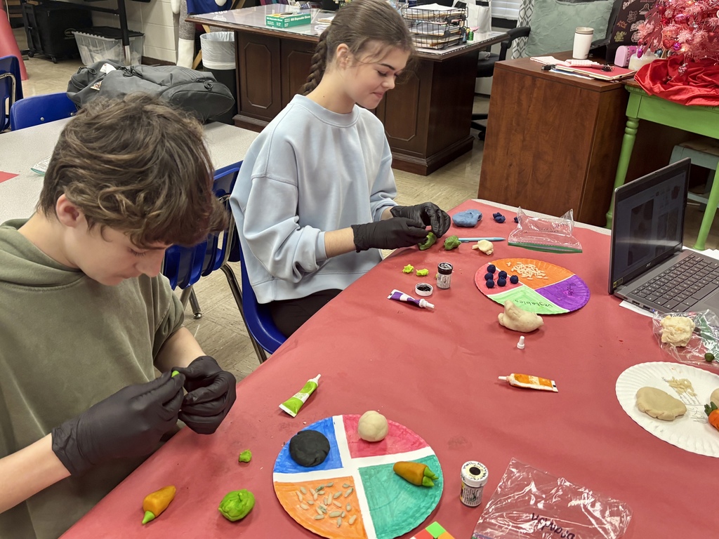 students shaping Play-Doh into foods