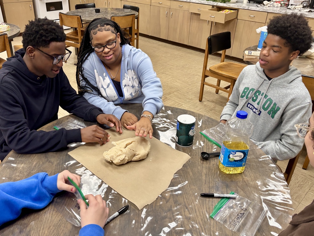 students at table shaping Play-Doh