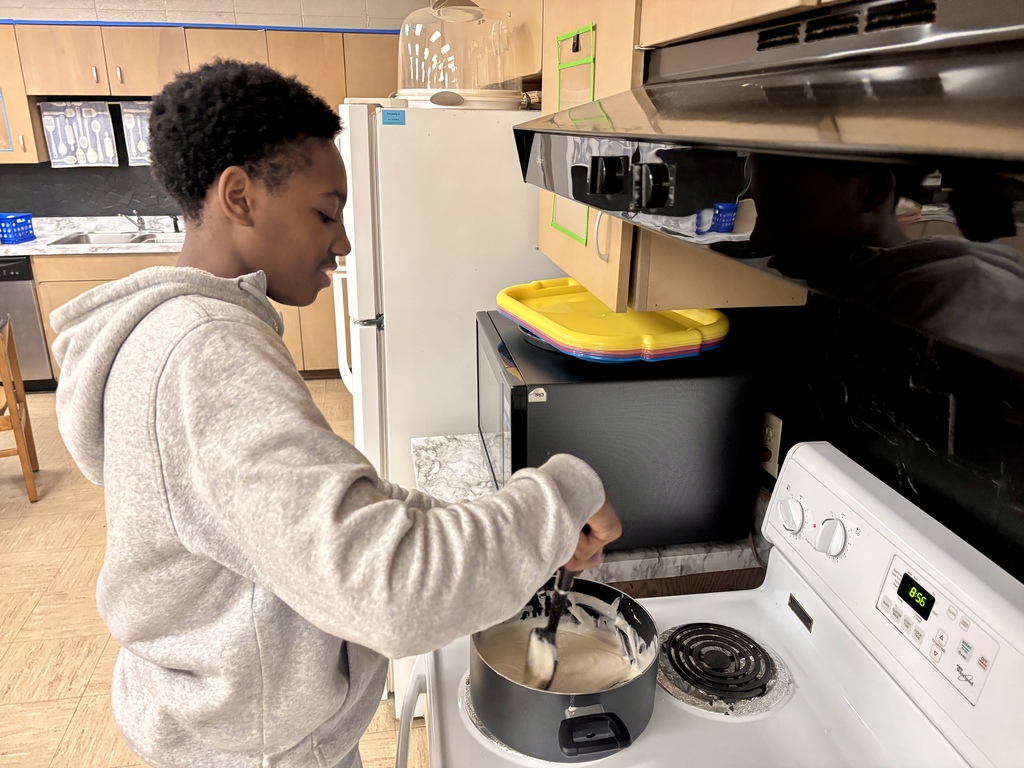 student cooking Play-Doh on a stove