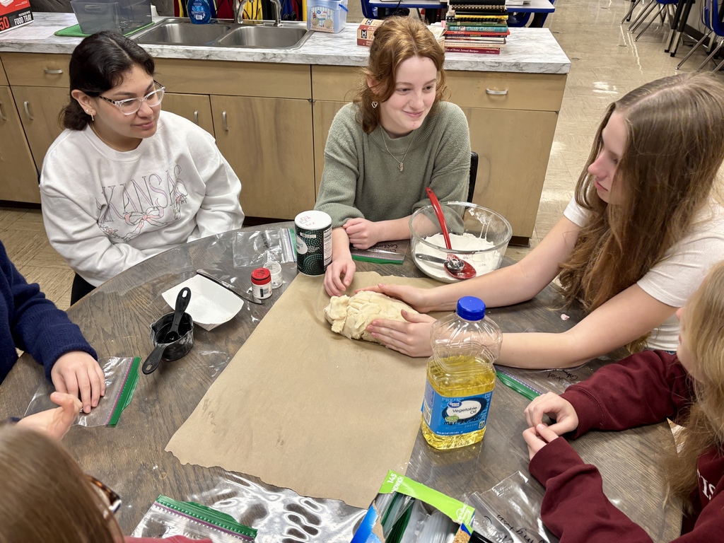 students at table shaping Play-Doh