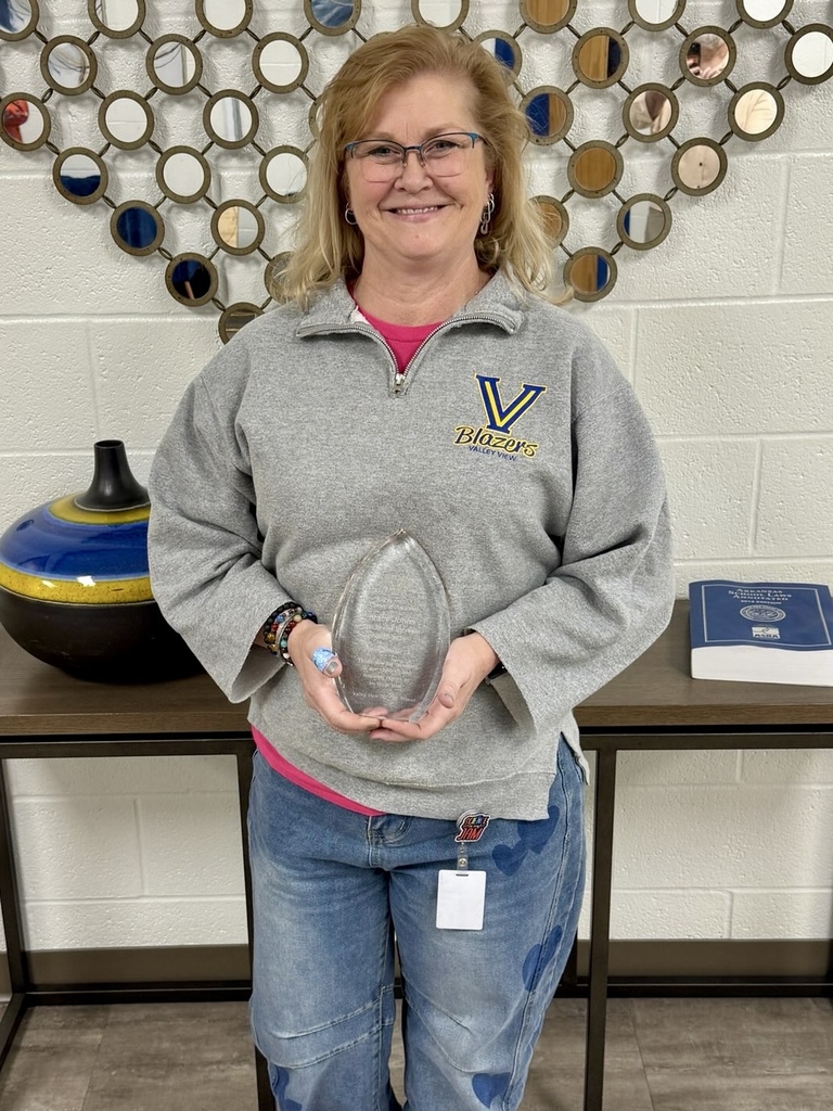 teacher of year, Stacy Johns, holding award