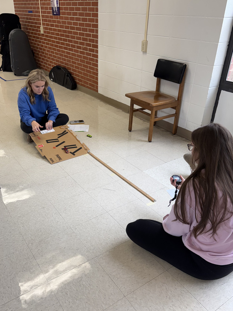 girls preparing to roll their Hot Wheels cars