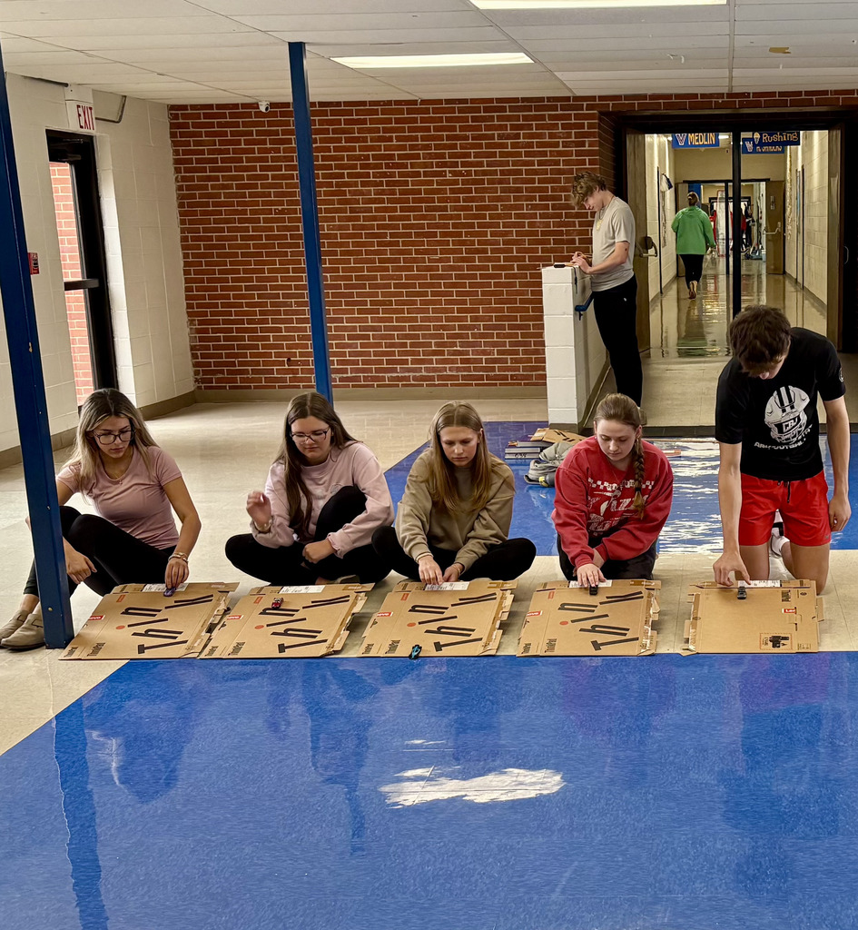 five students experimenting with Hot Wheels cars