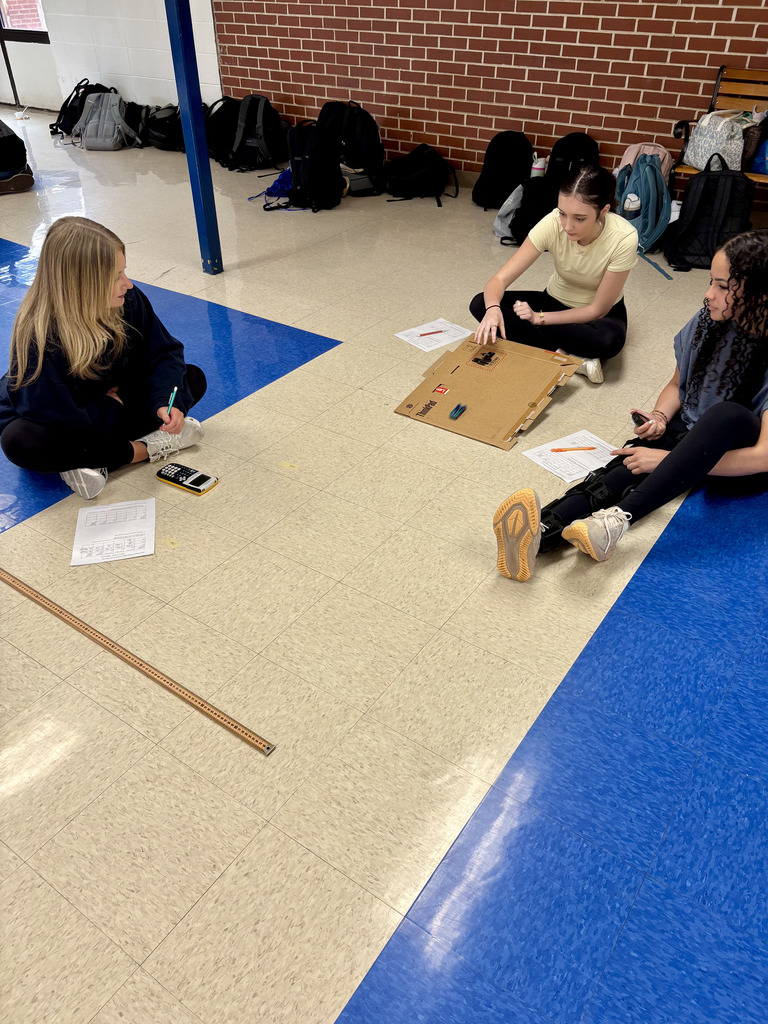 three girls experimenting with Hot Wheels cars