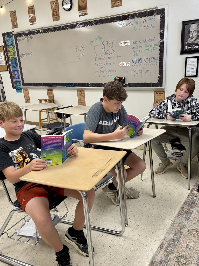 boys reading at their desks in class